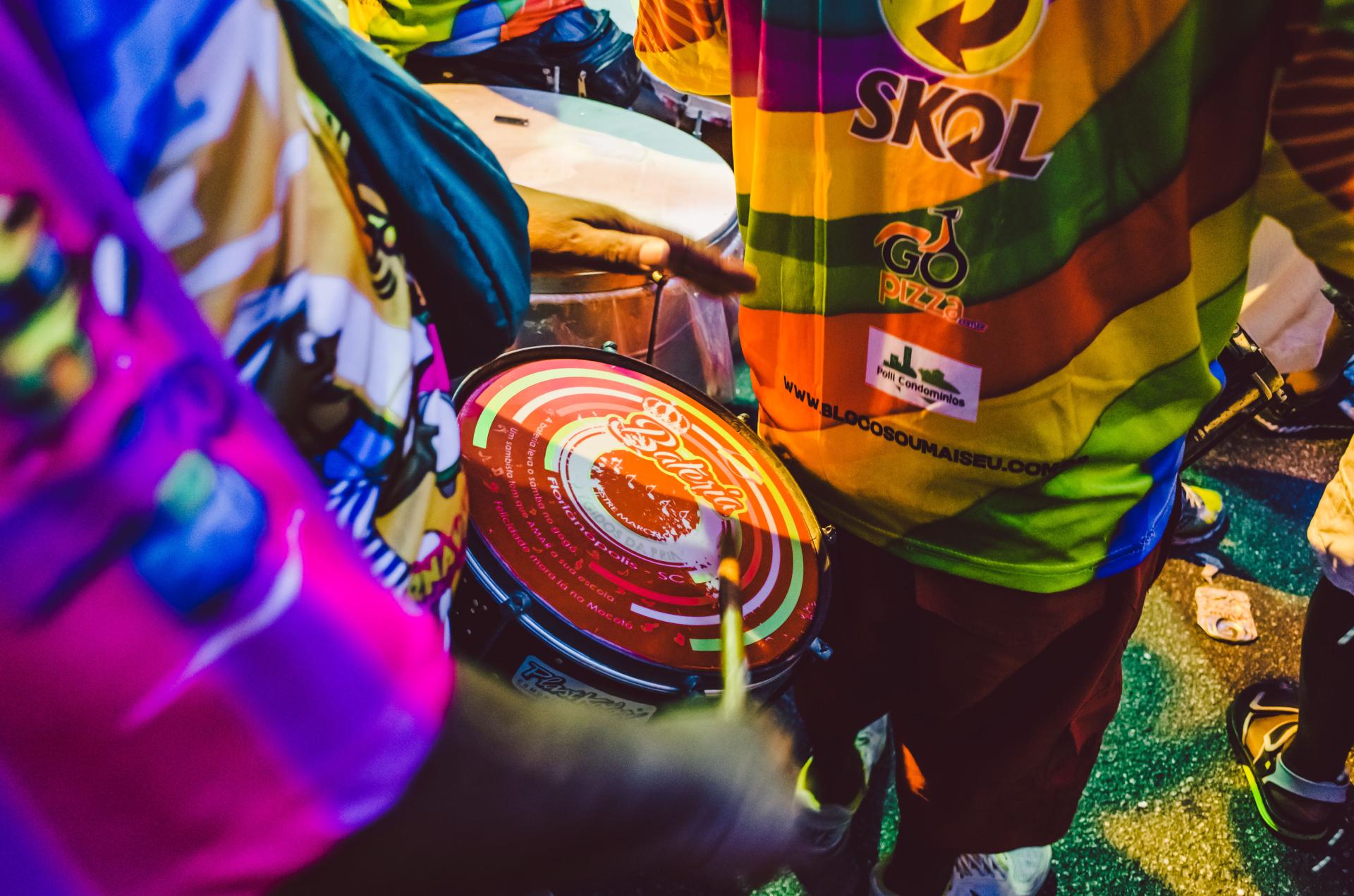 Close-up of drummers in rainbow outfits at an LGBTQ+-friendly carnival in Brazil