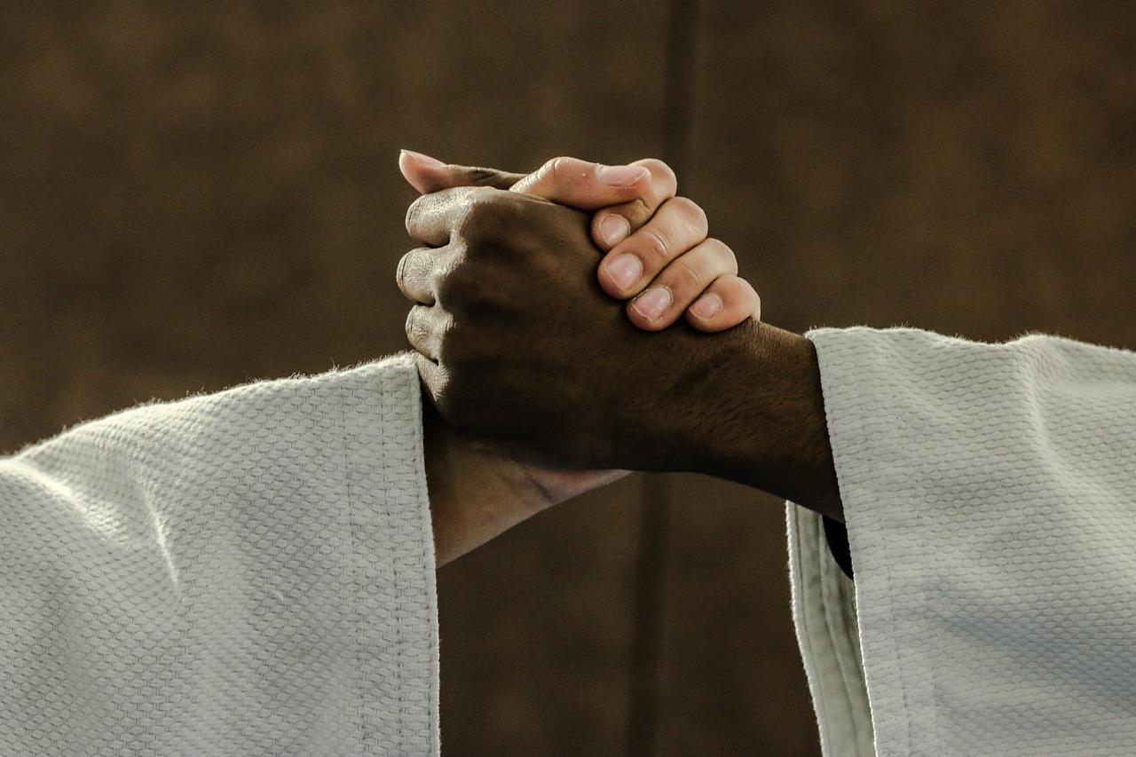 Judo stands for respect, discipline and cooperation Two judoka shaking hands