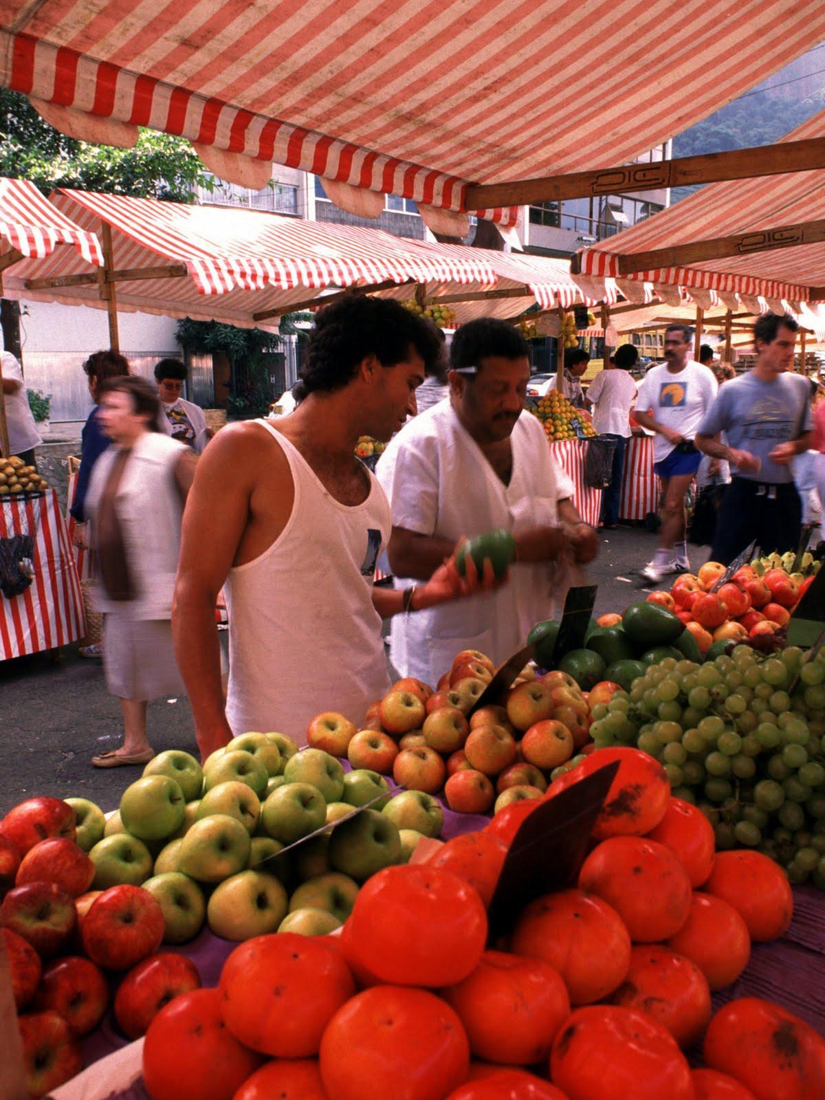 Trader and customer shopping at a market in Rio Shopping at a market in Rio