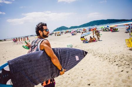 Surfers on the beach of Campeche in Florianopolis