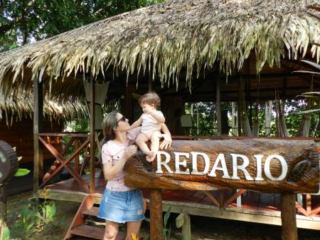 A mother and a child in front of an open air hammock lounge