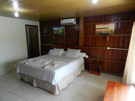 Example of a double room with air conditioning and wooden interior at Amazon Turtle Lodge
