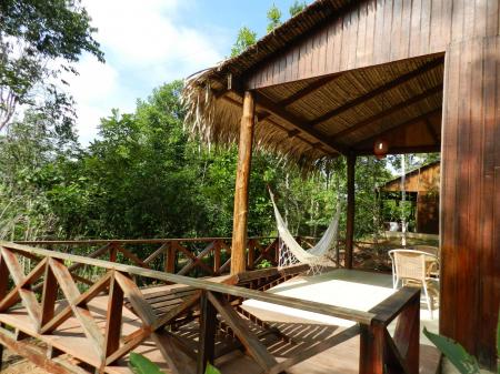 An example of a wooden bunglow with private outdoor area and hammock