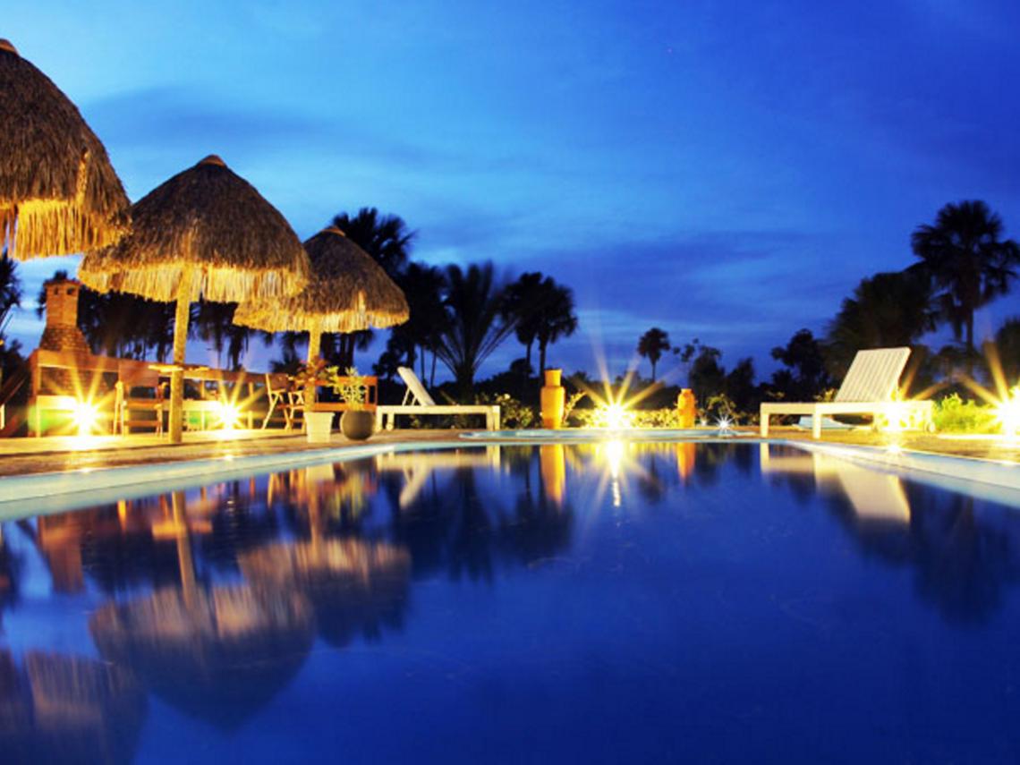 Outdoor pool at night at Pousada Encantes do Nordeste