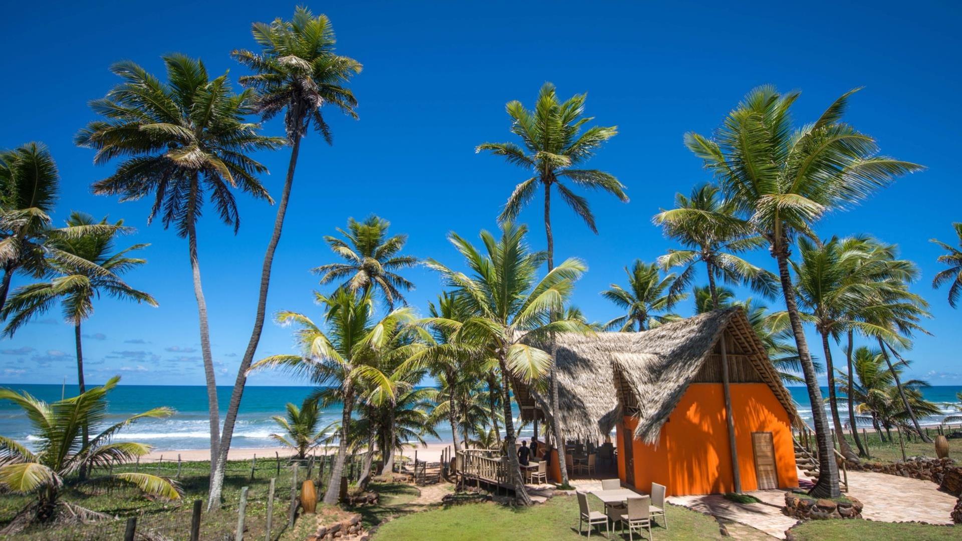 Pousada Capitu, with its colorful wooden bungalows directly on the beach of Imbassai