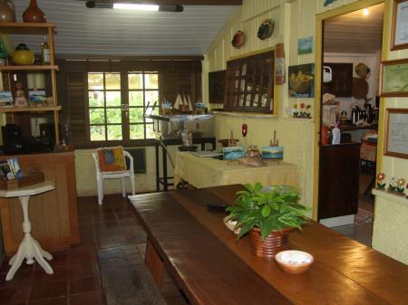 Cozy living room with wooden furniture at Pousada Enseada das Conchas