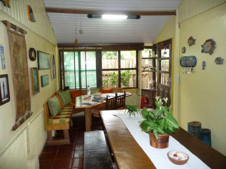 Large table and many seats with wooden furniture at Pousada Enseada das Conchas