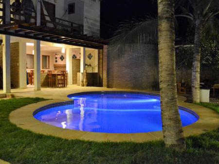 Pool area with palm trees at Pousada Bella Jeri