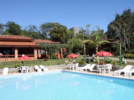Pool area with seats and green garden at Hotel Sao Sebastiao in Florianopolis - Brazil