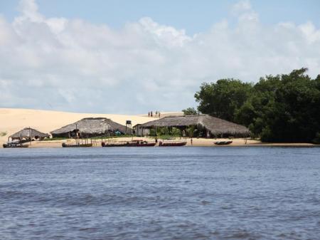 Boats ariving at a local beach restaurant surounded by dunes, Lencois Maranhenses