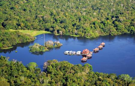 View on the river with 7 floating facilities of the Uakari Lodge