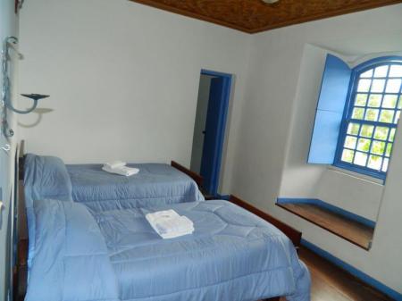 Twin beds in a room of Posuada do Caraca, in the mountains of Minas Gerais, Brazil