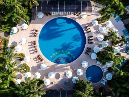Aerial view of two round pools with chairs and umbrelas at Vivaz Cataratas Hotel Resort