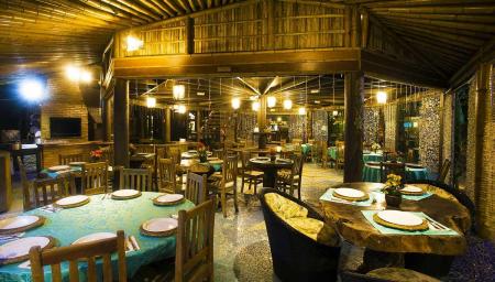 Typical beach bungalows with wooden furniture at Grajagan Surf Resort, Ilha do Mel