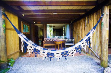Cozy double rooms with wooden furniture at Grajagan Surf Resort, Ilha do Mel