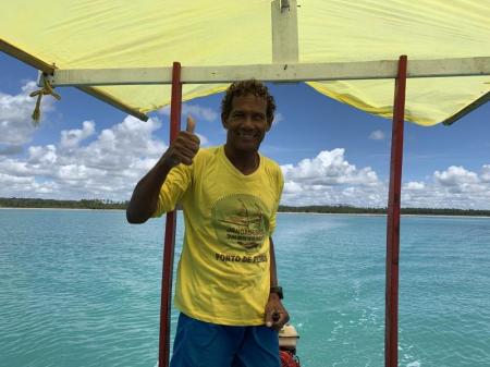 Tourguide on a covered boat in the sea of Praia da Lage