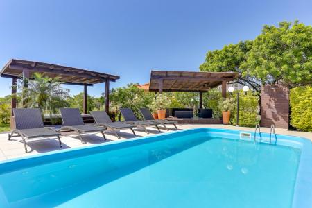 A large pool with relaxation areas at Pousada Ilha Faceira in Florianopolis