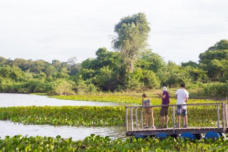 Visitors enjoying the river view at Pousada Aguape