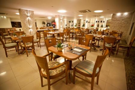 Tables and chairs in the local restaurant of Hotel Celi Aracaju