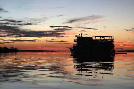 The cruise ship is anchoring during sunset 