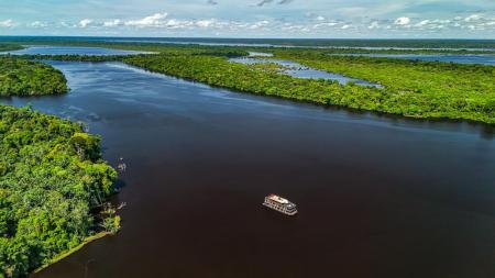 A wide aerial photo of the Zaltana boat on a river